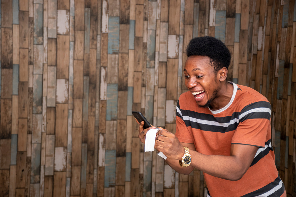 A,Young,African,Man,Feeling,Happy,And,Excited,Holding,His